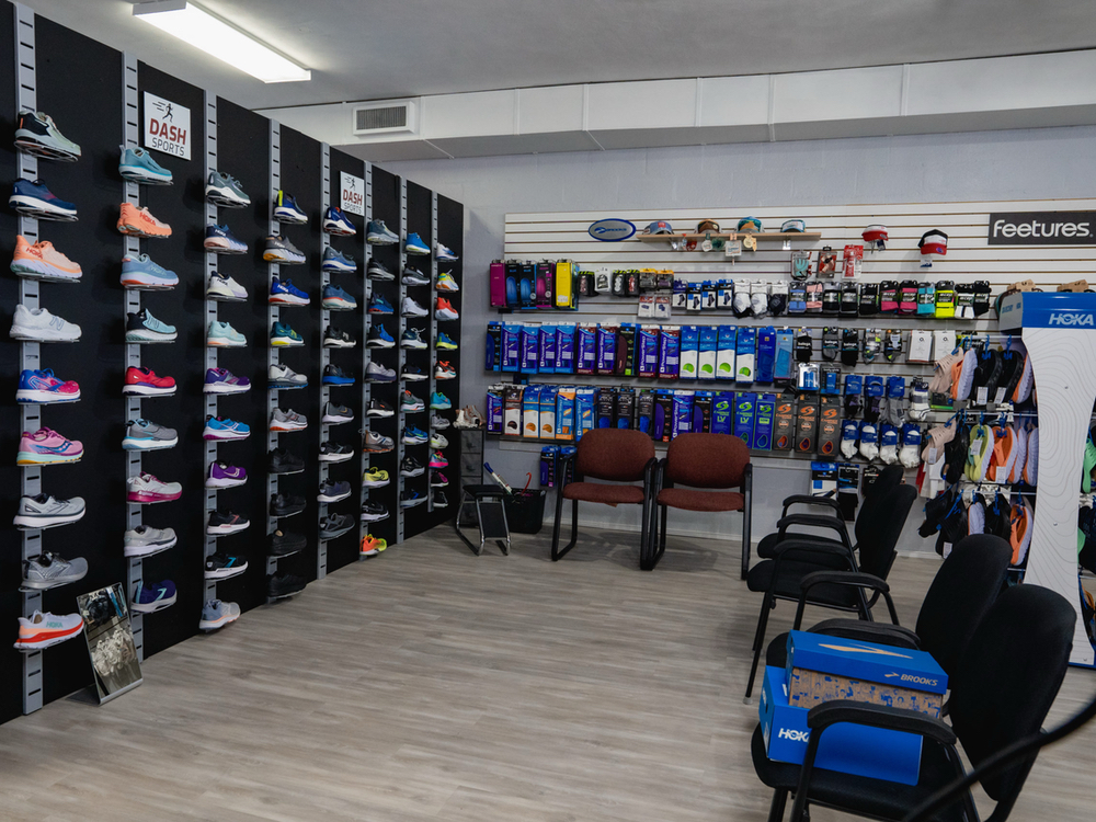 Wall of running and walking shoes inside the Dash Sports store in Clermont, FL