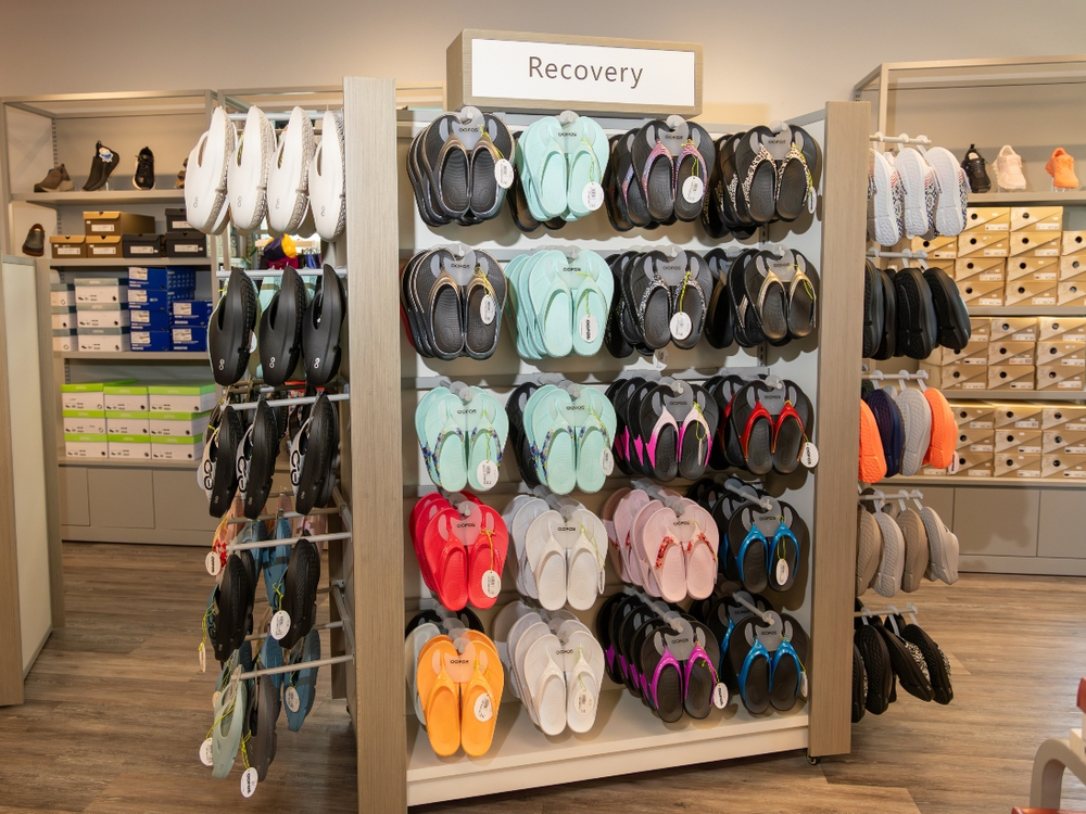 Wall of Brooks, HOKA, and New Balance shoes inside the Dash Sports store in Clermont, FL