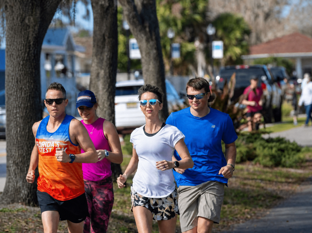 Runners on a tree-lined street in Clermont, FL, one of the best places to run in South Lake County