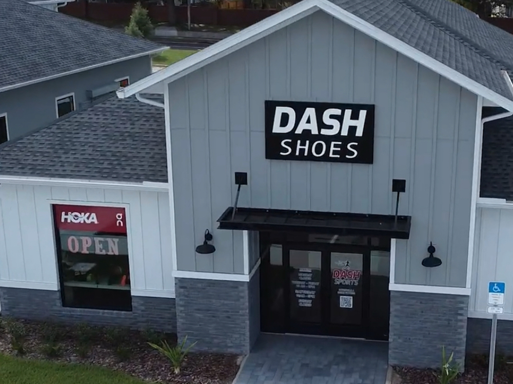 Exterior of the Dash Sports store on Stoneybrook West Parkway in Winter Garden, FL with the open sign lit
